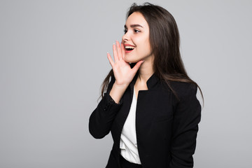Young woman screaming with wide open mouth isolated on gray wall background