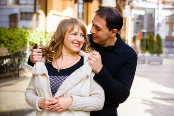 Happy middle age couple in love having fun outdoors and smiling. Romantic happy couple kissing and hugging. Sentimental happy couple in love bonding