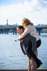 Happy middle age couple in love having fun outdoors and smiling. Romantic happy couple kissing and hugging. Sentimental happy couple in love bonding