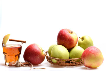 Set of fruit placed in wicker bowl near tea glass