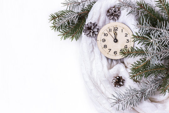 white background with new year's clock, with branches of spruce, snow and cones