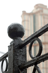 Closeup of black metal fence in the city