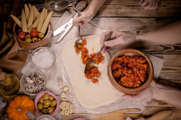 Mother and daughter make home-made pizza. Home-made pastries and cooking. Traditional Mediterranean cuisine