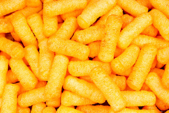 Cheese puff texture pattern background. Cheese puff snack snacks as background.