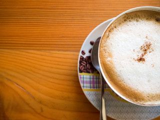 A cup of coffee on wood table ,on wooden background.