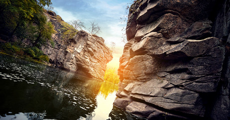 River in a stone canyon at sunset