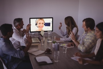 Business people talking to expert through video conference
