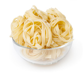 Uncooked nests of tagliatelle pasta isolated on white background with clipping path