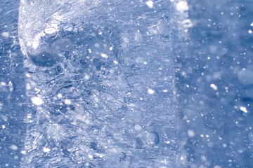 Texture of ice in winter. Pieces of frozen water on a street in 