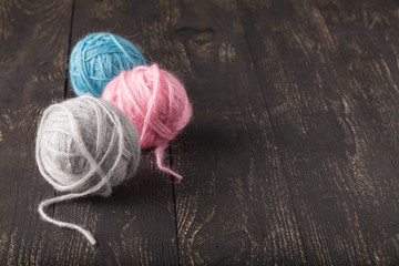 wool ball of threads on wooden table