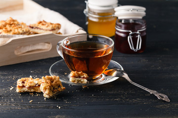 Wooden tray with a cup of tea and cookies