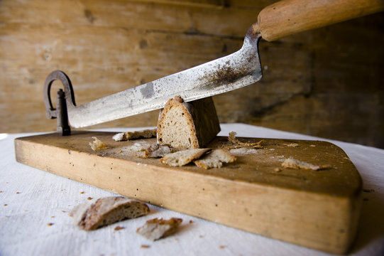 Old bread on a bread slicing machine, baking, homemade