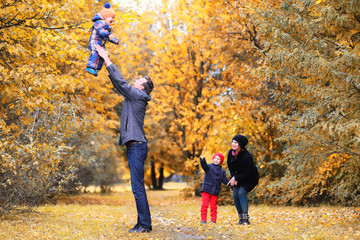 Family in autumn park in the afternoon