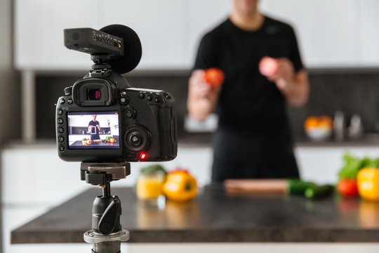 Close up of a video camera filming young man