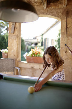 Girl playing billiards at a roofed terrace, Algaida, Mallorca, Balearic Islands, Spain