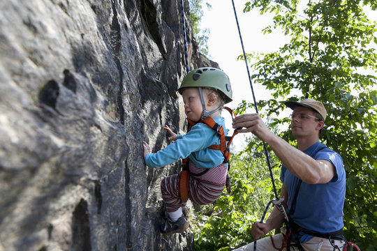 Boy (2 years) climbing in a quarry, Leipzig, Saxony, Germany