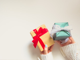 celebration concept for christmas and new year event by beauty woman hand hold two gift box for offer to her respect person with isolated white background