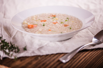close up of a healthy taste barley soup with root vegetables