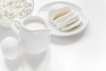 Fototapety  Healthy food concept with milk and cottage cheese on white table
