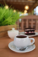 Kettle with a drink and dessert in a street cafe. Tea in the ket