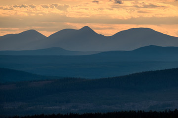 Layered mountains during sunset