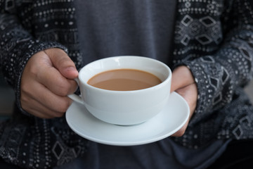 Close up of  female holding hot big white cup of coffee , Concept warm winter and morning with coffee