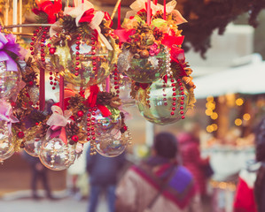 Naklejka premium Christmas decoration against lights blurred background. Focus on decoradet Christmas balls