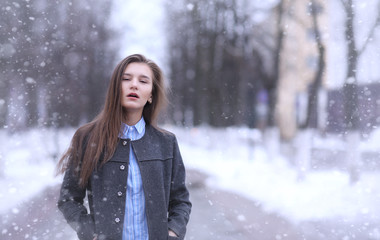 Young girl outdoors in winter. Model girl posing outdoors on a w