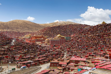 Red monastery and home at Larung gar (Buddhist Academy) in sunshine day and background is blue sky, Sichuan, China.
