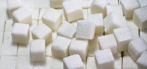 Sugar. Sugar is white, lumpy, refined. Background.