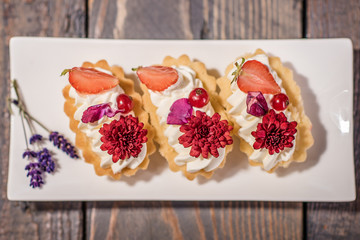 close up of a cream cake decorated with edible flowers