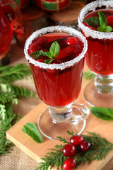 Hot cranberry tea in an Irish mug decorated with sugar on a wooden board