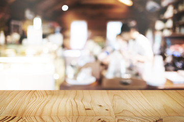 empty wooden table in front of blur coffee shop cafe or restaurant background