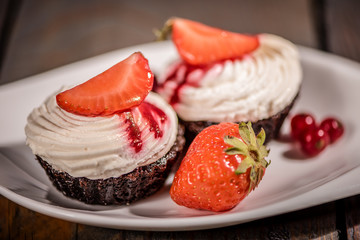 chocolate cupcake with cream and fruit