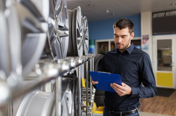 auto business owner and wheel rims at car service