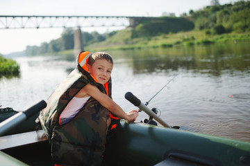happy boy swimming in fishing boat