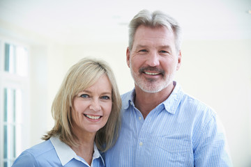Portrait Of Loving Mature Couple At Home