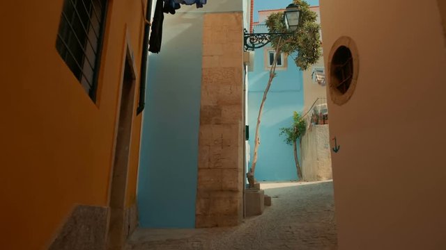 Walking along empty streets of Alfama, the oldest district of Lisbon, Portugal, on the slope of Sao Jorge.  Alfama boasts many historical attractions along with Fado bars and restaurants.