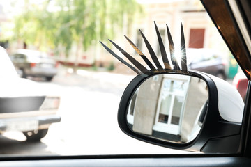 Car with eyelashes on side view mirror outdoors