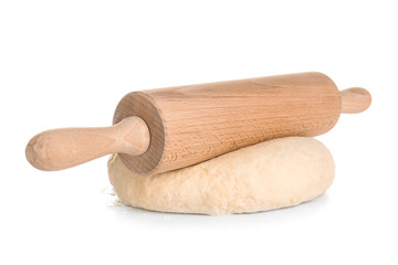 Raw dough with rolling pin on white background