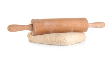 Raw dough with rolling pin on white background
