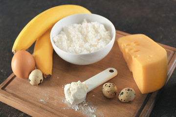 High protein food and powder on wooden board