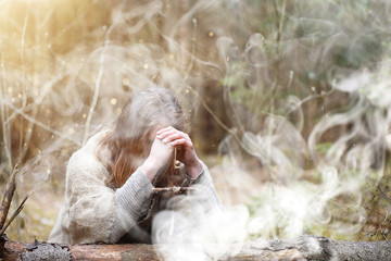 A man in a cassock spends a ritual in a dark forest