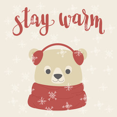 Fototapeta na wymiar Polar bear in a warm scarf and ear warming