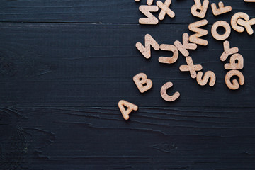 Close up wooden alphabet study english letters,ABC on the blackbroad as a background composition