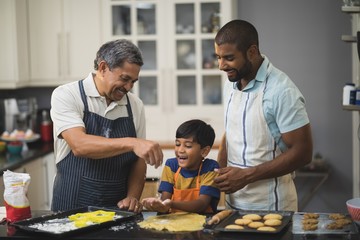 Multi-generation family preparing food in kitchen