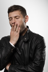 Male portrait in leather jacket in studio