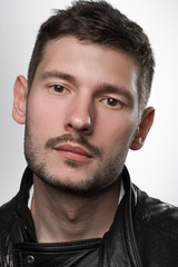 Naklejka premium Male portrait in leather jacket in studio
