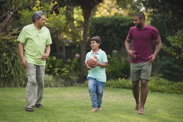 Boy with father and grandfather at park