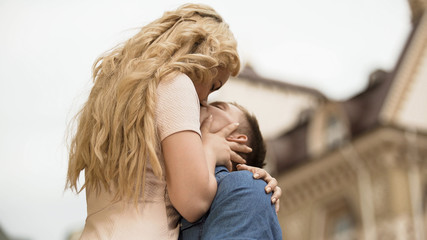 Boyfriend raising his girlfriend up and kissing her, passionate relationship